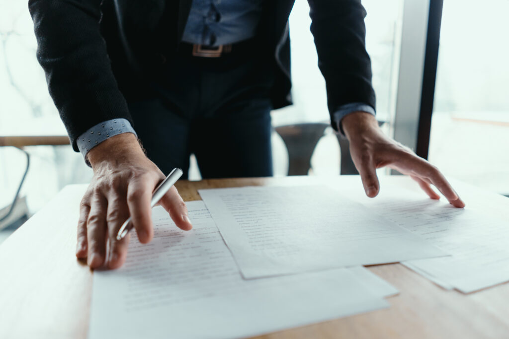 man organizing papers on a desk
